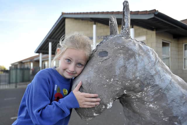 Ryhope Infant School Academy pupil Esme gives their Ryhope Pony a cuddle Picture by FRANK REID