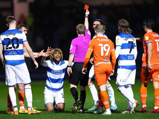 LONDON, ENGLAND - FEBRUARY 23: Dion Sanderson of Queens Park Rangers receives a red card from Gavin Ward, the match referee during the Sky Bet Championship match between Queens Park Rangers and Blackpool at The Kiyan Prince Foundation Stadium on February 23, 2022 in London, England. (Photo by Jacques Feeney/Getty Images)