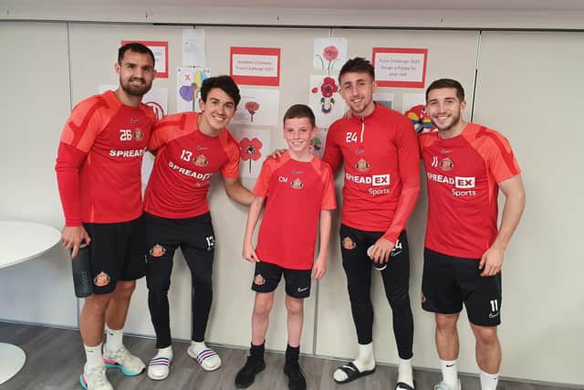 SAFC players Bailey Wright, Luke O'Nien, Dan Neil and Lynden Gooch with U12s Academy player Charlie Morton, who they judged to have designed the best poppy.