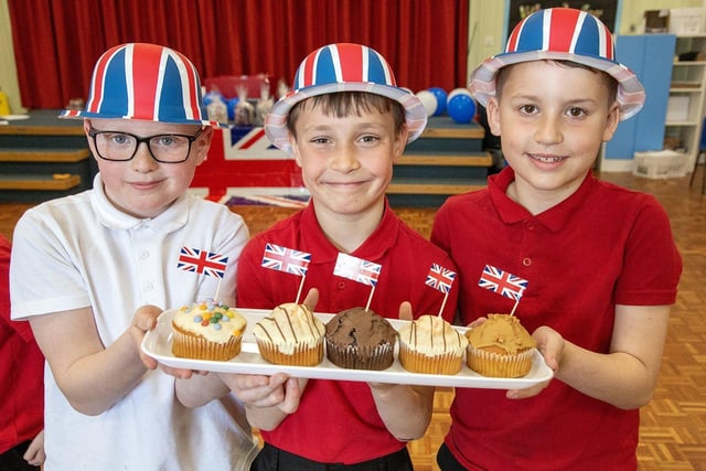 Plains Farm Academy pupils Isaac Warrener,  Kayden Rose and Jacob Harris show some of the cakes on offer at their Coronation tea party.