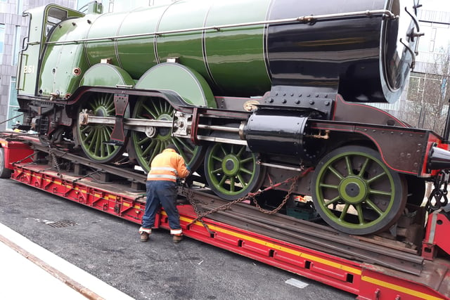 A worker removes chains as engine number 251 arrives in Doncaster Museum on the back of a lorry