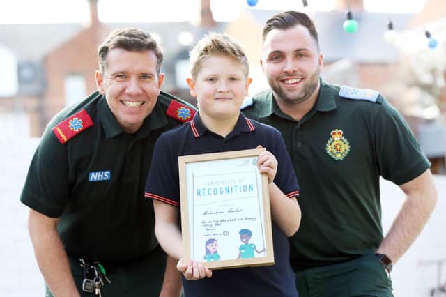 Sebastian Fowler with NEAS paramedic Andy Wilson, left, and student paramedic Louis Smart, right.