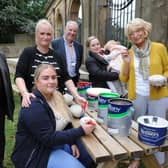 Creating the first stones for the new memorial garden at the Sunderland Fans Museum are Karen and Megan Matthews, Carol King and daughter Quinn, and committee member Dorothy Stewart, watched by SAFC legend Bobby Kerr (left) and Gentoo's John Ford