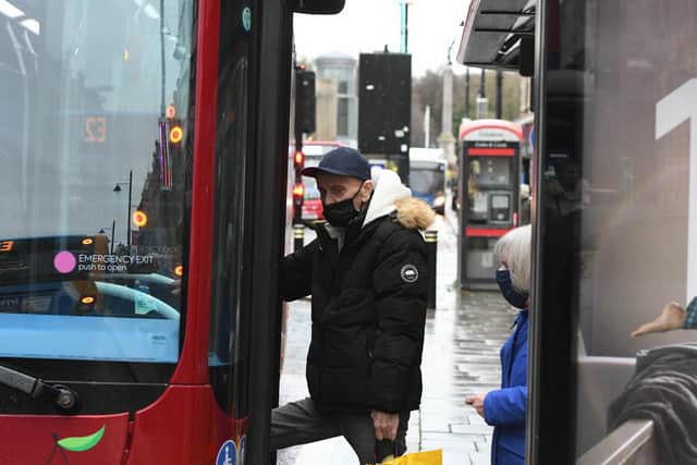 Members of the public wear masks as they prepare to board a bus on Tuesday morning at the start of new Covid regulations.