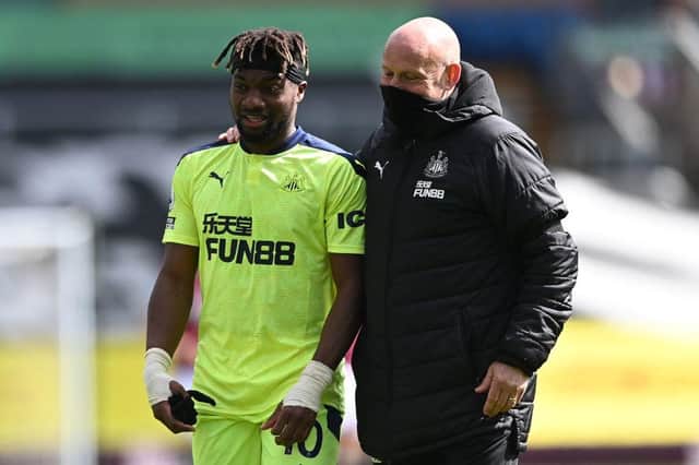 Newcastle United's French midfielder Allan Saint-Maximin (L) celebrates with Newcastle United's First Team Coach Steve Agnew after winning the   English Premier League football match between Burnley and Newcastle United at Turf Moor in Burnley, north west England on April 11, 2021. -