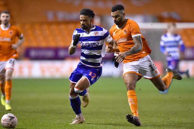 Garath McCleary of Reading and Curtis Tilt of Blackpool battle for the ball.