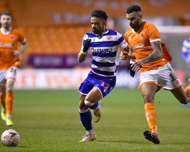 Garath McCleary of Reading and Curtis Tilt of Blackpool battle for the ball.