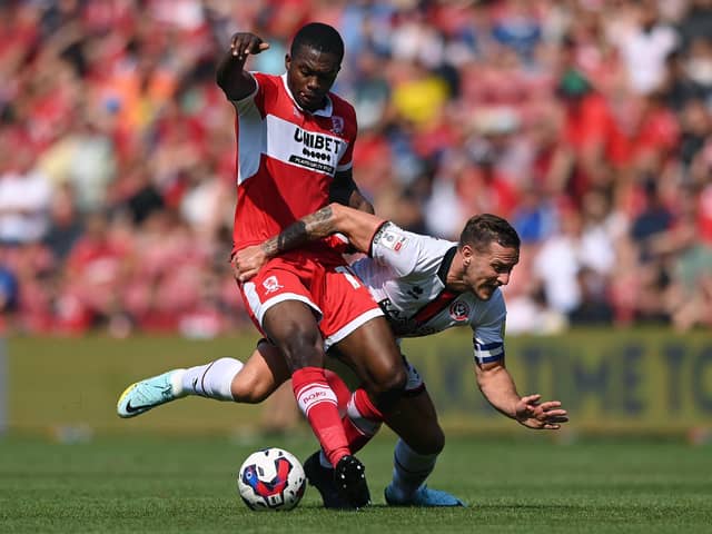 MIDDLESBROUGH, ENGLAND - AUGUST 14: Middlesbrough player Anfernee Dijksteel challenges Billy Sharp of Sheffield United during the Sky Bet Championship between Middlesbrough and Sheffield United at Riverside Stadium on August 14, 2022 in Middlesbrough, England. (Photo by Stu Forster/Getty Images)