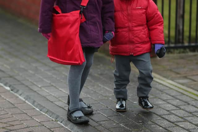 Schoolchildren make their way to primary school in Leeds, Yorkshire, as schools across England return after the Christmas break.