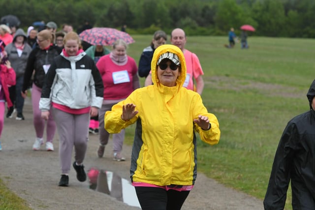 A runner brings a smile to our day with her yellow raincoat. Good luck on your run!