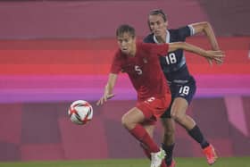 Canada's Quinn, left, and Britain's Jill Scott battle for the ball during a women's soccer match at the 2020 Summer Olympics, Tuesday, July 27, 2021, in Kashima, Japan. (AP Photo/Fernando Vergara)