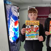 Shane and Warren Brewster with copies of Marcus Rashford's book and comic.