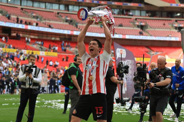 Luke O’Nien lifting the League One play-off final trophy at Wembley. Picture by FRANK REID