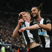 Matty Longstaff of Newcastle United celebrates with team-mate Andy Carroll after scoring against Manchester United.