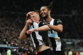 Matty Longstaff of Newcastle United celebrates with team-mate Andy Carroll after scoring against Manchester United.