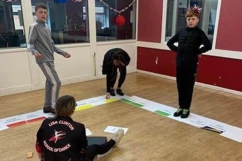 Youngsters playing human monopoly.