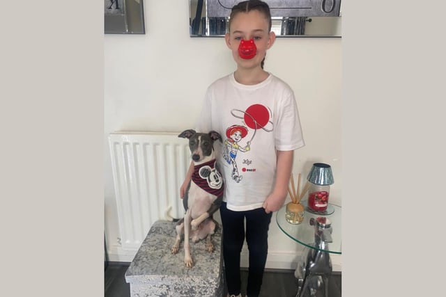 Poppy in her Toy Story t-shirt, with Rocco the dog also showing his support with a festive bandana.