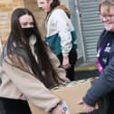 Students Madison Slee, 16, and Kirsty Young, 17, delivering some of the 3,000 tins.