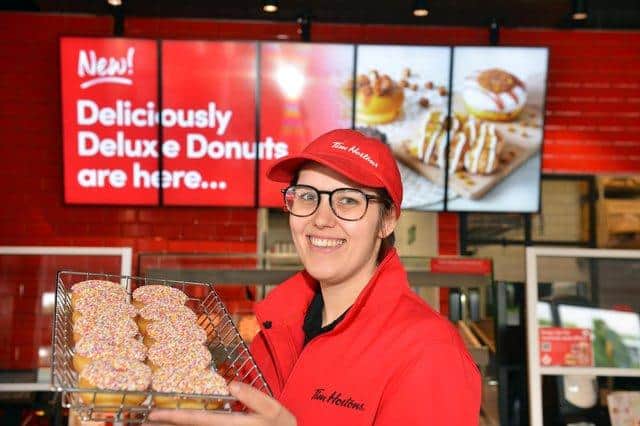 Restaurant manager Amy Appleby with a selection of Tim Hortons doughnuts.