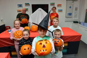 Children of Armed Forces veterans with their Halloween pumpkins at the Beacon of Light.