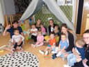 Headteacher Claire Nicholson (left) with staff and children at the nursery.