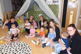Headteacher Claire Nicholson (left) with staff and children at the nursery.