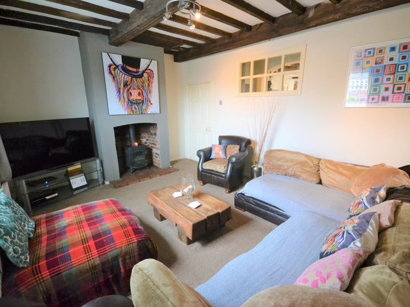 A great-sized room which could have a number of uses, with exposed beam work to the ceiling and a feature fireplace.