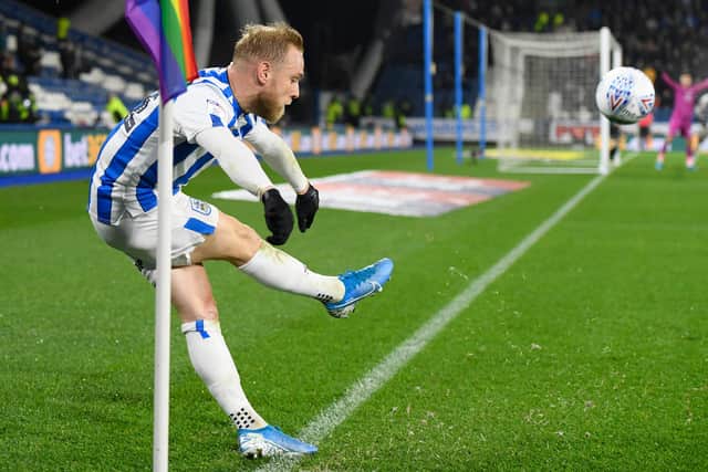 HUDDERSFIELD, ENGLAND - NOVEMBER 26: Alex Pritchard of Huddersfield Town takes a corner next to rainbow corner flag during the Sky Bet Championship match between Huddersfield Town and Swansea City at John Smith's Stadium on November 26, 2019 in Huddersfield, England. (Photo by George Wood/Getty Images)