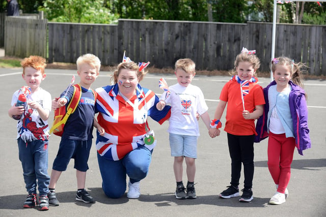 Children and staff at Town End Academy wave their Union Jack flags to celebrate Queen's 70 years on the throne.