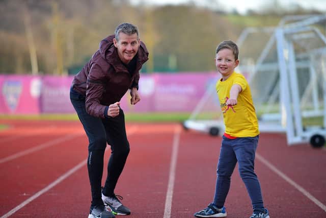 Steve Cram with George Lumley (7) at the launch of the Durham City run festival held at Maiden Castle. Picture by FRANK REID