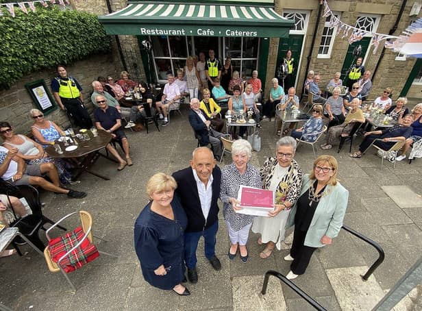 The Mayor of South Tyneside Councillor Pat Hay (2nd right) presents a gift to Fran and Peter Hooper from the Village Cafe, Whitburn to mark their 50th year in business. As The Mayoress Mrs Jean Copp (right) and the Leader of South Tyneside Council Councillor Tracey Dixon look on. Also photographed are members of the public who called at the cafe to congratulate Fran and Peter. Picture by FRANK REID