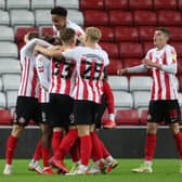 Sunderland players celebrate scoring against Manchester United Under-21s in the Papa John's Trophy.