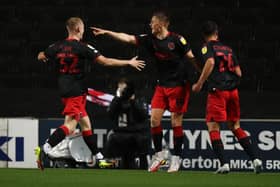 Fleetwood players celebrate after scoring against MK Dons.