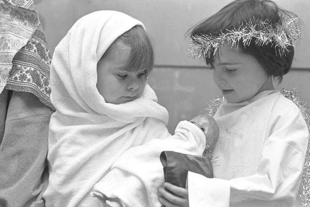 Four year olds Kerry Ann Hewitson (left) and Jack Sanderson make sure the doll is well wrapped up before taking part in Backfell Infants' School Nativity in 1974.