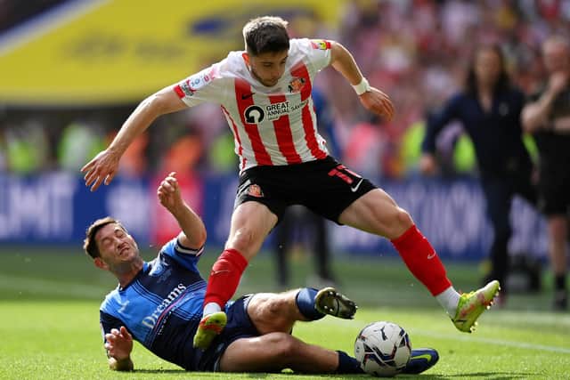 LONDON, ENGLAND - MAY 21: Lynden Gooch of Sunderland is challenged by Joe Jacobson of Wycombe Wanderers during the Sky Bet League One Play-Off Final match between Sunderland and Wycombe Wanderers at Wembley Stadium on May 21, 2022 in London, England. (Photo by Justin Setterfield/Getty Images)