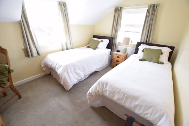 The guest house's twin room is described as a "pleasant and sunny room situated at the rear of the property".