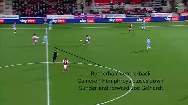 Sunderland forward Joe Gelhardt drops deep to receive the ball but is closed down by Rotherham centre-back Cameron Humphreys.
