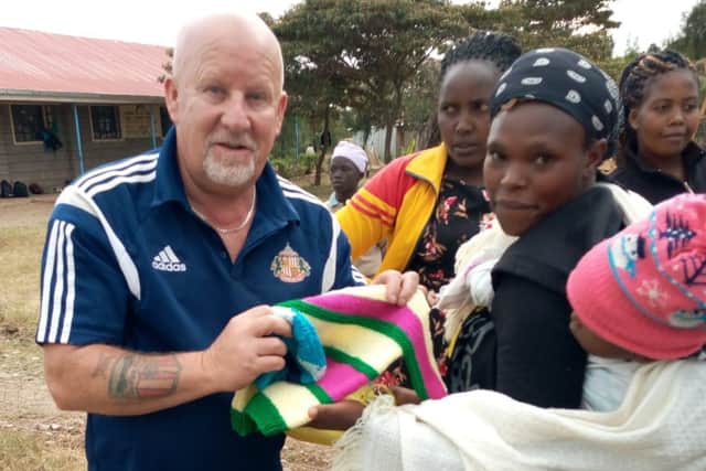 Gary hands out donations of clothing in Keroche.