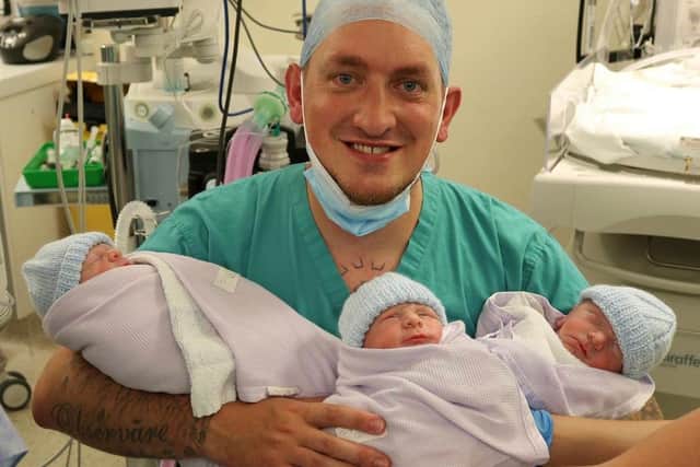 Proud dad, Alex Lindsay, with triplets Abel, Asher and Azariah.