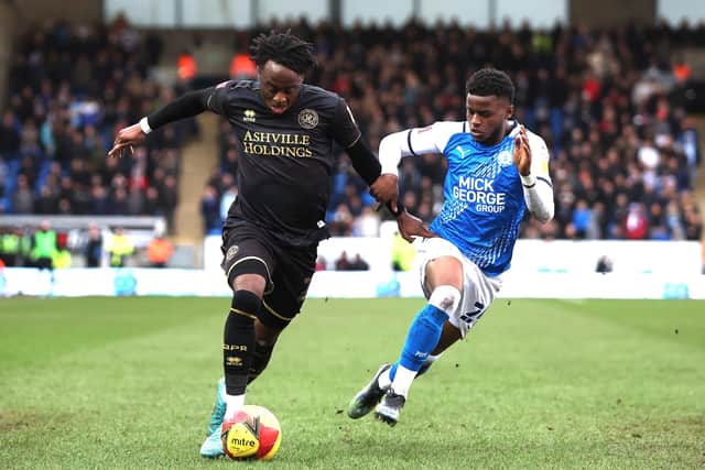 PETERBOROUGH, ENGLAND - FEBRUARY 05: Bali Mumba of Peterborough United challenges Moses Obubajo of Queens Park Rangers during the Emirates FA Cup Fourth Round match between Peterborough United and Queens Park Rangers at ABAX Stadium on February 05, 2022 in Peterborough, England. (Photo by Mark Thompson/Getty Images)