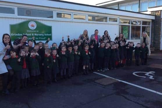 Staff and pupils at Grindon Infant School giving a thumbs up to their recent good Ofsted judgement.
