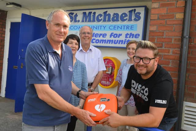 St Michael's Community Centre receive a defibrillator from  Red Sky Foundation founder Sergio Petrucci with help from Denis Crompton, Cllr Michael Dixon, Jackie Robson and Liz McEvoy.