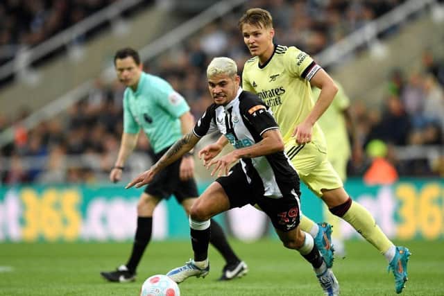 Arsenal's Norwegian midfielder Martin Odegaard (R) vies with Newcastle United's Brazilian midfielder Bruno Guimaraes during the English Premier League football match between Newcastle United and Arsenal at St James' Park in Newcastle-upon-Tyne, north east England on May 16, 2022.  (Photo by OLI SCARFF/AFP via Getty Images)