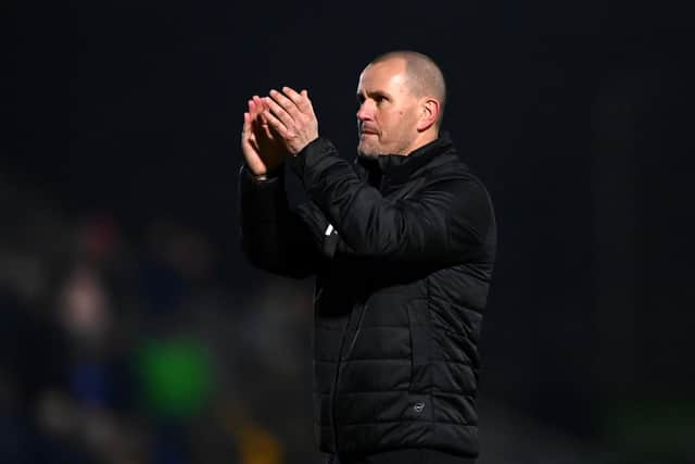 WIMBLEDON, ENGLAND - JANUARY 25: AFC Wimbledon Manager, Mark Robinson acknowledges the fans after duri the Sky Bet League One match between AFC Wimbledon and Ipswich Town at Plough Lane on January 25, 2022 in Wimbledon, England. (Photo by Alex Davidson/Getty Images)