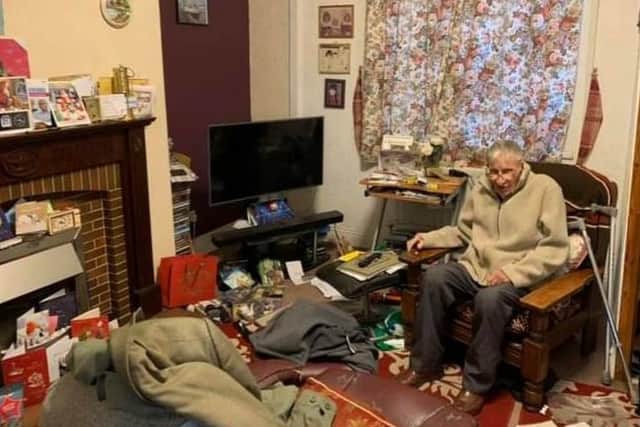 Edwin Green, who is known as Ted, in the living room of his home after it was ransacked by burglars.