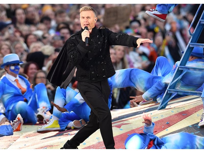 Gary Barlow looking dapper in a black military-style jacket with a cloak.