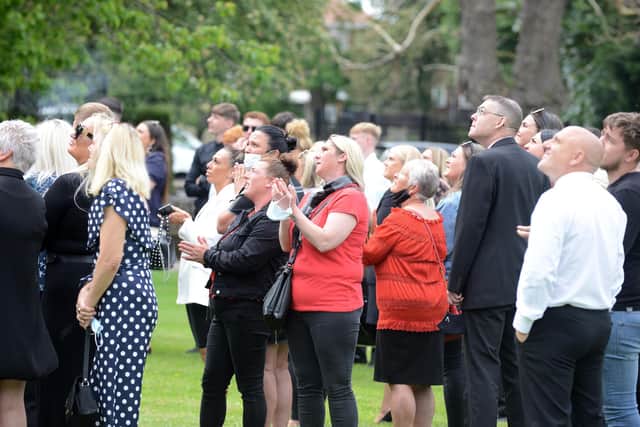 People watch on as doves were released following the funeral of Sam Murphy.