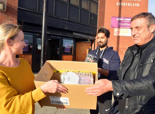 Katarzyna Posnik receives donations of toiletries for Ukrainian families from local businessman Darren Naylor and Cllr Usman Ali.