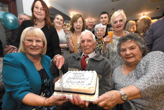Billy Davison celebrates his 100th birthday in the Hastings Hill surrounded by family including daughter Joyce, front left and cousin Nancy, front right. Picture by Ian McClelland.