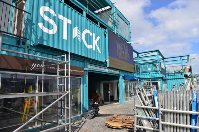 The main entrance to STACK on the Coast Road, with Yolo coffee shop and Downey's fish and chips either side